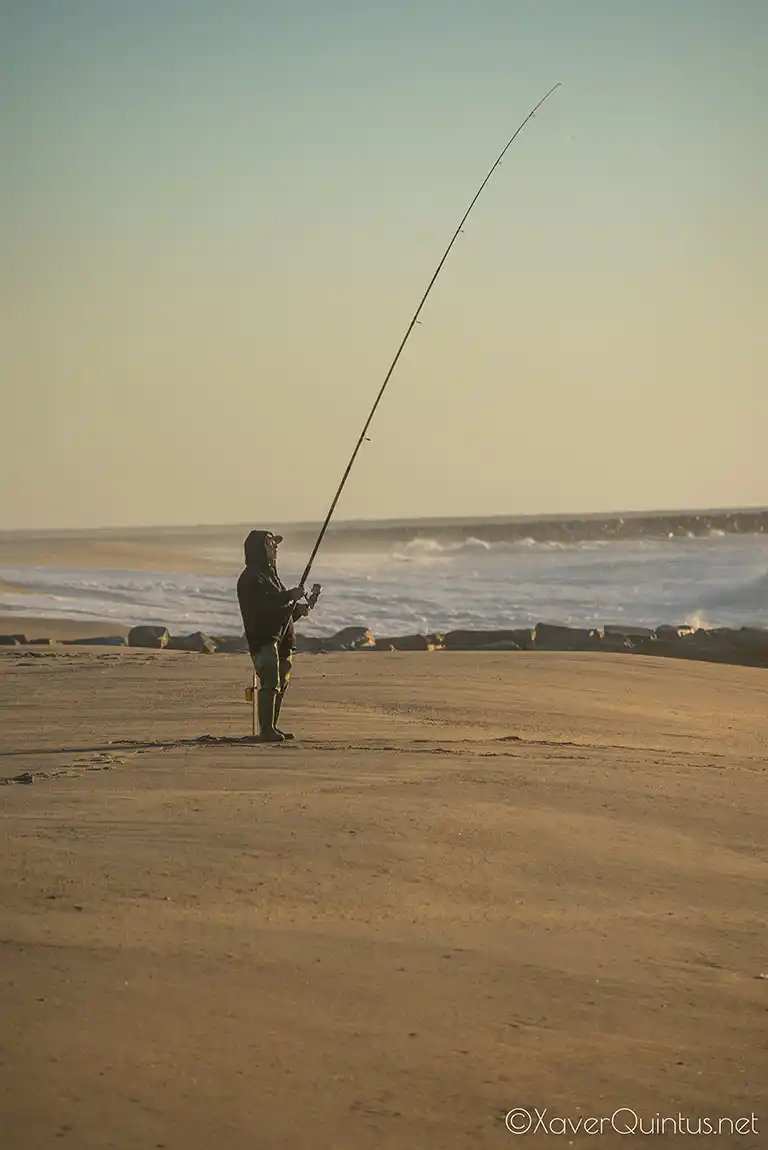 Fisher on beach